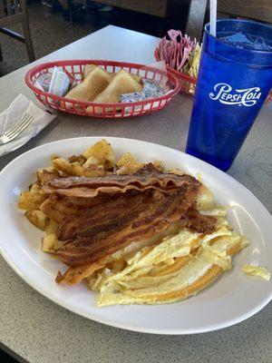 2 eggs scrambled w/ cheese, double order of bacon extra crispy, home-fried-potatoes, and toast.