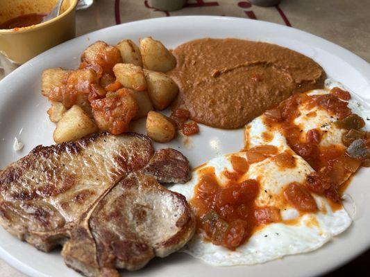 37. Chuleta de Puerco Pork Chop breakfast plate with sauce on the side so I could put it where I want. Delicious!