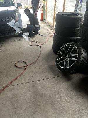 He's putting on the tire