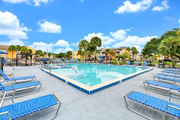 Large swimming pool surrounded by lounge chairs