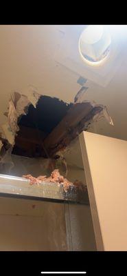 Hole in ceiling where water was pouring from.