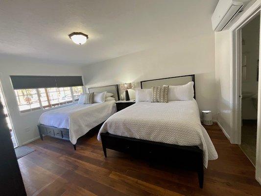 An inside view of our Piñon Suite. This room includes double queen beds.