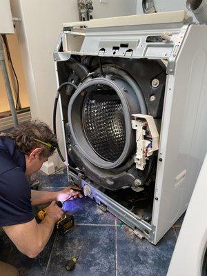 Steven working on a Samsung front loader washing machine.