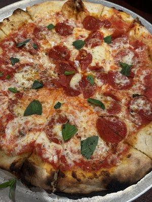 Pepperoni pizza with basil