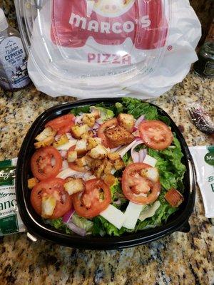 Family size chef salad with fresh lettuce, tomatoes, ham, turkey, provolone cheese, a few red onions topped with garlic croutons.