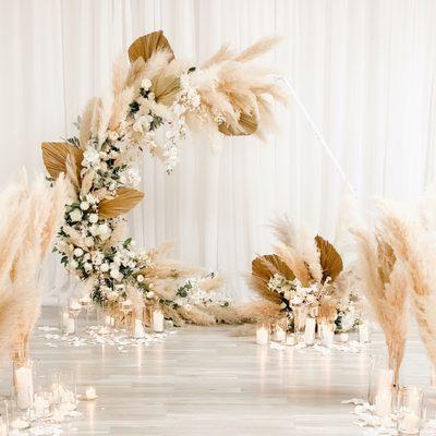 Wedding arch design with pampas grass, flowers, and candles. Wedding florist and designer Fort Lauderdale. Wedding reception decorations