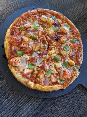 Half and half chicken and paneer deluxe pizza