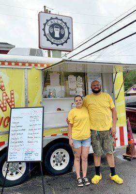 Owners with menu beside the "Flippen Yellow Truck"