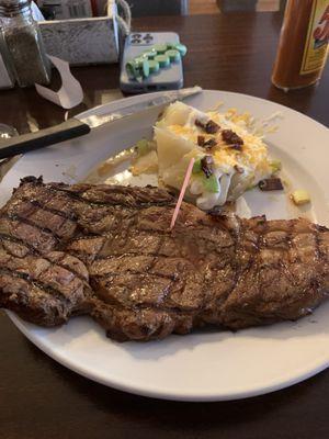 12 oz Ribeye, not the best cut but acceptable with half cooked baked potato. Check out how the "chef" presented the potato