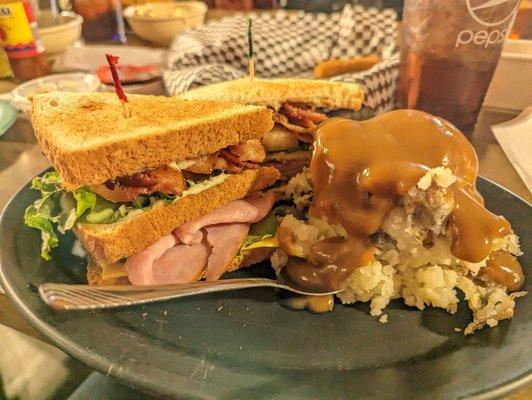 Club sandwich with mashed potatoes and brown gravy