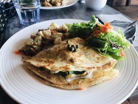 Half Moon Bay savory crepe with a side of potatoes and mixed greens