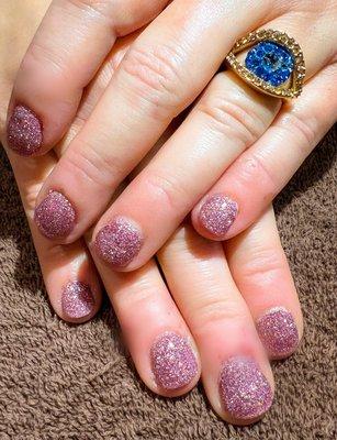 Pink glitter dip manicure .