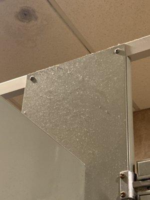 That's dust on the bathroom stall and something nasty dripping from the ceiling.