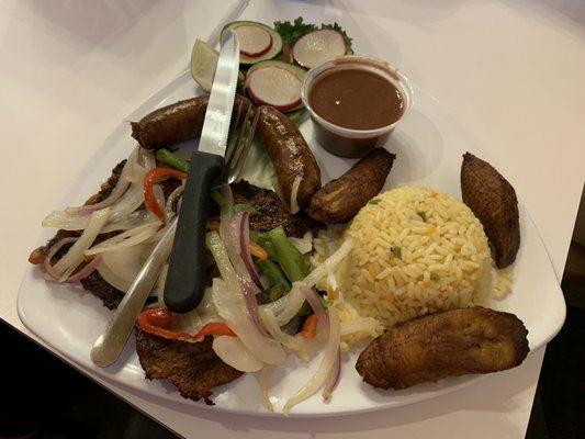 Asado migueleno . Beef fajitas with sausage, fried plaintain , fried rice and been sauce