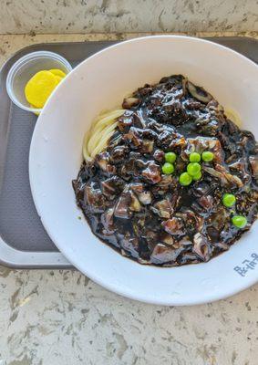 Jajangmyeon is a Korean Chinese dish of noodles topped with a thick, savory black bean sauce.