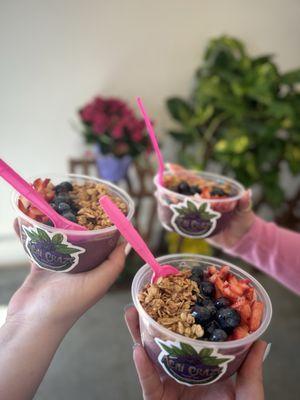 Açaí bowl with strawberries, blueberries, vanilla berry crunch granola, and honey drizzle