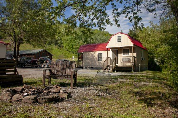 View of the cabins from the firepit, next to the Bluestone River.