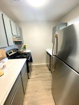 Galley kitchen located in the Cypress Layout with upgraded stainless steel appliances.