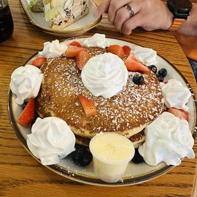 Pancake stack with berries and cream