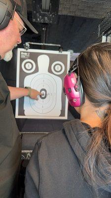 Paul is pointing out the bull's-eye on the first ever fired shot. :)