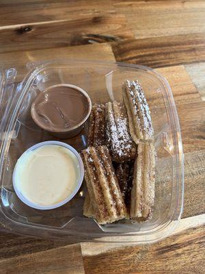 Churros with white and milk chocolate, churros dusted in cinnamon and powdered sugar