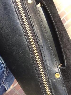 Uneven loose stitching on the repair job.