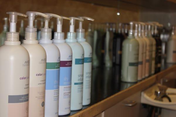 AVEDA shampoos and conditioners lined up to enhance your experience