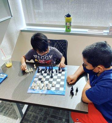 Students Learning How To Play Chess