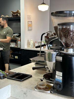 The main barista and his workstation.