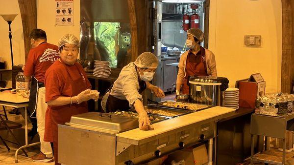 Staff on right collect fee ($7 lunch, $1 bottle water), and the other 2 staffs by the serving table serve rice and vegetarian dishes.