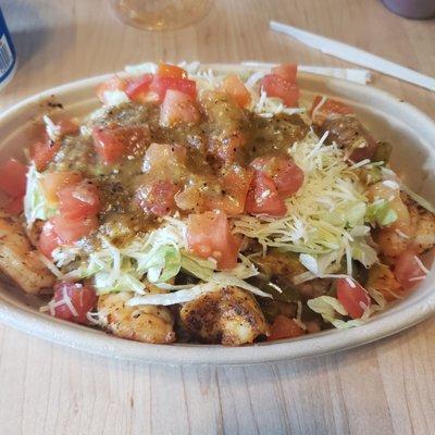 Shrimp fajita bowl with Spanish rice, refried beans, lettuce, tomato, hot salsa, cheese