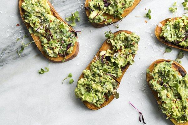 Avocado Sweet Potatoast - Toasted sweet potato rounds topped with smashed avocados, lemon, red pepper flakes, spirulina, and chia seeds