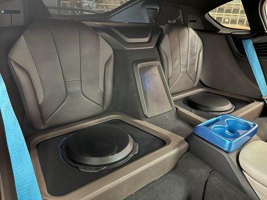 BMW i8 rear seat delete for 2 JL Audio TW3 10 inch subwoofers.