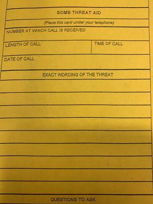 bomb threat report by each phone and on desks... gotta love the military's love of paperwork