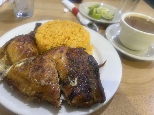 Half a roasted chicken  yellow rice , beans near by. Yum.