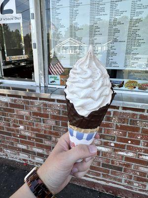 Nutella peanut butter soft serve in a chocolate dipped waffle cone