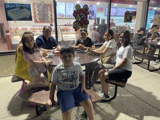 A family enjoying Cold Stone ice cream outside.