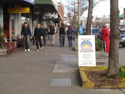 The Library hours vary; when the Library is open, the sandwich board sign is out on the sidewalk.