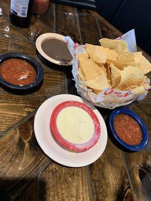 White queso with complementary bean dip and salsa