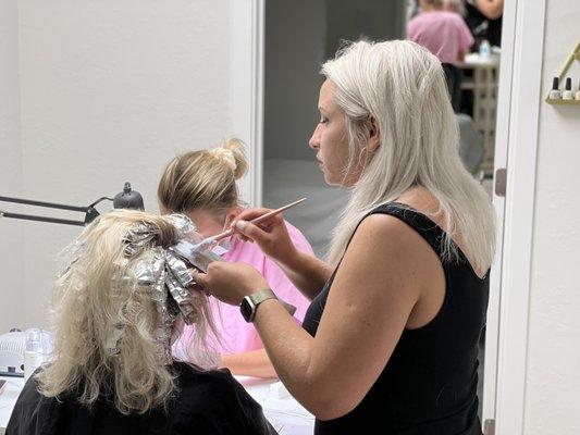 Hair Coloring and Manicure at the same time.