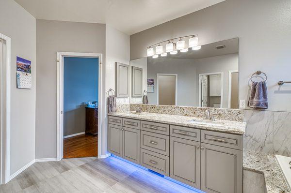 Manchester master bath after. New double sink vanity with undermount sinks and mathcing medicine cabinet. Granite countertop. New tile floor