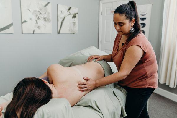 Angelica doing a sedation/relaxation stroke on either side of the spine.