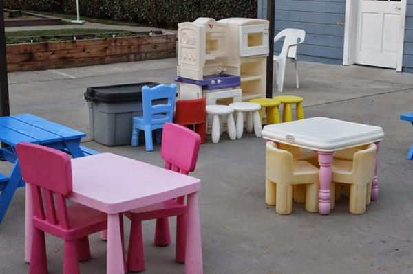 Play kitchen, dress up clothes, and lots of play space.  The other side is all trikes, cars and basketball hoops.