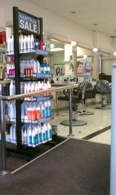 Racks of hair care products and some of the cutting stations are visible on the left as you enter the store.