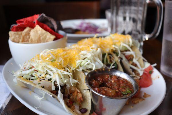 Alaskan Halibut Tacos $28
 Blackened Alaskan halibut, black bean pico de gallo, shredded cabbage, three cheese blend on soft corn tortillas.