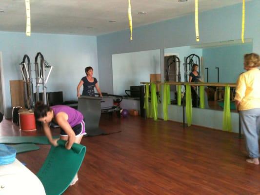 Inside studio... There are two reformers, ballet bares for booty bare and trx straps hanging from the ceiling