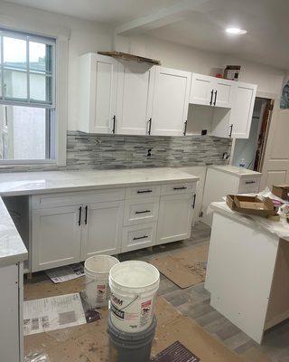 Kitchen backsplash and cabinets installed