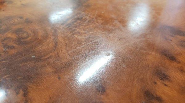 Tables and chairs are showing much age and scratches.