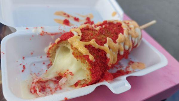 Breaded Corn Dog with Cheese and Sausage inside, Flamin Hot Cheetos on the outside and Spicy Mayo