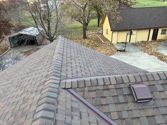 Top of main house looking at detached garage and shop.